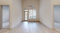 This contemporary apartment in Plano, Texas, offers 1060 square feet of meticulously designed living space. The two-bedroom, three-bathroom layout maximizes functionality and comfort. The primary bedroom, at 140 square feet, provides ample space for relaxation. High ceilings throughout create an airy atmosphere, while large windows flood the rooms with natural light, offering views of the surrounding area.

The open-concept design seamlessly integrates the living areas, highlighted by sleek, light-toned flooring. The kitchen is a focal point, featuring modern appliances, a central island, and a harmonious blend of white and dark cabinetry. Pendant lighting adds a touch of elegance to the space.

Bathrooms showcase a luxurious feel with marble-look tiles, spacious vanities, and glass-enclosed showers. The apartment includes two closets with built-in shelving systems for optimal organization. Every detail, from the ceiling fans to the window treatments, contributes to the overall modern aesthetic of this urban dwelling.