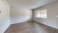 Located at 701 E Bay Drive in Largo, Florida, this single-floor, one-bedroom, one-bathroom unit offers a practical and well-organized layout. The living room serves as the main gathering space, featuring durable wood-look vinyl plank flooring, neutral gray walls, a textured ceiling, and a dedicated entry door with a smart lock. A pass-through counter connects the living area to the kitchen, adding functional convenience. Natural light enters through a large window, contributing to a bright and open feel throughout. The bedroom is a comfortable, carpeted retreat with access to a closet and a connecting door to the hallway. Sliding glass doors open to an outdoor area, allowing additional natural light and outdoor access. The bathroom is clean and straightforward, equipped with a full-size soaking tub and shower combo, a toilet, towel bar, and wood-look flooring that coordinates with the rest of the unit. Soft, neutral tones are carried throughout the space, creating a cohesive and calm aesthetic. The closet provides dedicated storage, contributing to the overall functionality of the unit. This well-laid-out space is ideal for those seeking a manageable, low-maintenance residence in the Largo, FL area.