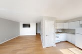 Located at 736 Campbell Ave in Ypsilanti, Michigan, this single-floor, 2-bedroom, 1-bathroom unit offers a clean, functional layout with a cohesive neutral color palette and light hardwood flooring throughout. The open-concept main living area seamlessly combines the living room, dining room, and kitchen into one bright, airy space. Large windows with vertical blinds allow generous natural light to pour into the living area, creating a welcoming atmosphere. The kitchen features white cabinetry extending to the ceiling for ample storage, marble-style countertops, a gas range, a full-size refrigerator, and a stainless steel sink — all finished in a crisp, uniform white. A hallway connects the main living area to the two bedrooms, bathroom, and utility room. The primary bedroom offers a comfortable footprint with a built-in closet. The second bedroom includes open shelving and closet space. Three closets are distributed throughout the unit for additional storage. The full bathroom is outfitted with a tub-shower combo and a white vanity. A dedicated utility room rounds out the practical layout. Overall, the unit presents a bright, move-in-ready aesthetic with consistent finishes and efficient use of space.