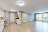 Located at 1910 Chestnut Ave in Glenview, IL, this well-appointed 2-bedroom, 2-bathroom residence offers a thoughtfully designed single-floor layout. The open-concept main living area seamlessly integrates the living room, dining area, and kitchen, all finished with light-toned hardwood-style flooring and neutral gray walls that create a clean, contemporary atmosphere. Natural light flows in through a set of glass French doors in the living area, enhancing the sense of openness.

The kitchen is outfitted with white shaker cabinetry, light quartz countertops, a subway tile backsplash, and stainless steel appliances including a gas range and over-the-range microwave. Both bathrooms are finished with matching light wood-look flooring and white vanities with ample storage. One bathroom features a tub-shower combination, while the other offers a glass-enclosed walk-in shower. The spacious primary bedroom includes hardwood-style flooring and generous natural light, while the second bedroom features plush carpeting and a large window. Three closets, a dedicated laundry area, and a connecting hallway complete this practical and modern layout.