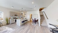 Located at 621 Homestead Avenue in Brighton, Colorado, this thoughtfully designed two-story home offers three bedrooms, four bathrooms, a dedicated office, and a convenient laundry room. The main level welcomes you with a bright, open entryway featuring light wood-style flooring and a built-in mudroom nook near the front door. The open-concept kitchen and living area is a standout, showcasing light wood cabinetry, granite-topped counters, a central island with seating, stainless steel appliances, and stylish pendant lighting — ideal for both everyday living and entertaining. Upstairs, the primary bedroom is generously sized with multiple windows that invite natural light and neighborhood views. Its en-suite bathroom features a dual-sink vanity with white quartz countertops, light lavender cabinetry, a glass-enclosed shower, and built-in shelving. Additional bedrooms are well-proportioned, each bright and carpeted, with access to bathrooms that mirror the home's clean, contemporary aesthetic. A dedicated office provides a quiet space for work or study. Throughout the home, a neutral color palette, recessed lighting, and consistent use of light wood flooring on main living areas create a cohesive, modern ambiance.