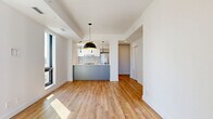Located at 600 Mountaineer Pvt in Ottawa, this modern 2-bedroom, 1-bathroom unit offers a thoughtfully designed open-concept layout finished with warm light wood flooring throughout. The combined living, dining, and kitchen area serves as the heart of the home, anchored by a striking kitchen featuring a two-tone design with white upper cabinetry, slate-grey lower cabinets, a white quartz peninsula with an integrated sink, stainless steel appliances, a tile backsplash, and a sleek range hood. Stylish pendant lighting — including a bold dome fixture with a gold interior — adds a contemporary accent. Large black-framed windows invite abundant natural light into the living area, which also features a built-in fireplace. Both bedrooms are bright and well-proportioned, each offering large windows with urban views and sliding closet doors for ample storage. The bathroom is finished in a clean, modern palette with large-format grey tile flooring, a glass-enclosed walk-in shower, a floating white vanity with an undermount sink, and recessed lighting. A dedicated laundry area and a hallway with additional closets round out the well-organized floor plan, making this a highly functional and stylish urban residence.