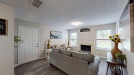 This single-story, one-bedroom, one-bathroom unit in Memphis, Tennessee offers a well-organized layout designed for comfortable everyday living. The living room serves as the heart of the home, featuring wood-style plank flooring, multiple windows that invite natural light, and a tile-surround fireplace that adds a warm, inviting focal point to the space. Neutral-toned walls throughout create a clean, versatile backdrop.

The dining area is conveniently positioned adjacent to the living space, providing a defined area for meals without feeling disconnected from the rest of the home. The kitchen is equipped with white cabinetry, granite-style countertops, a stainless steel sink, and a dishwasher, offering functional efficiency in a compact, well-appointed space.

The bedroom is generously sized, featuring plush carpeting, a ceiling fan, and a large sliding glass door that opens to a private outdoor patio with views of surrounding greenery, enhancing the sense of openness and connection to the outdoors.

The bathroom is neatly finished with wood-style flooring, a white vanity topped with granite countertops, a large mirror, and a shower-tub combination, providing a clean and practical design. Overall, the unit presents a cohesive, neutral aesthetic with thoughtful finishes throughout.