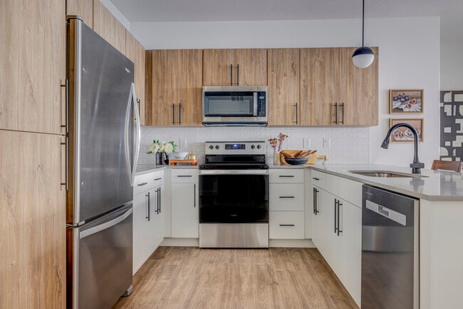 Kitchen with Black Appliances - The Foundry Apartments & Townhomes