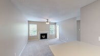 Located in Cincinnati, OH, this efficient one-bedroom, one-bathroom unit offers a well-organized single-floor layout. The living room is a welcoming focal point, featuring a classic fireplace framed by a white mantel, soft carpeting, a ceiling fan with light fixture, and a textured ceiling. Multiple windows flood the space with natural light, and a sliding glass door opens directly onto a private outdoor balcony with wooded views, extending the living area outdoors. The kitchen is compact and functional, equipped with white cabinetry, wood-toned accents, a double-basin sink, electric range, and durable wood-look flooring — providing all essential amenities in an efficient footprint. The bedroom is a comfortably sized retreat with plush carpeting and neutral-toned walls. It includes access to a dedicated walk-in closet with built-in shelving, offering generous storage. The bathroom features a full tub-shower combination with white tile surround, a large vanity mirror, multi-bulb light fixture, and a clean, classic finish. Throughout the unit, a consistent neutral color palette and soft carpeting create a calm, cohesive ambiance. The private balcony with its scenic greenery adds an appealing outdoor connection to this Cincinnati residence.