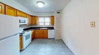 Located in Morris Plains, New Jersey, the Old Forge A6 residence is a thoughtfully designed 1-bedroom, 1-bathroom unit that maximizes comfort and functionality throughout its single-floor layout. Warm, polished hardwood flooring runs continuously through the main living areas, reflecting natural light and lending a bright, welcoming ambiance to the space.

The living area features a ceiling fan with integrated lighting and a sliding glass door dressed with vertical blinds, allowing generous natural light to fill the room. An open pass-through connects the living space seamlessly to the kitchen, which is appointed with warm-toned wood cabinetry, dark granite-style countertops, tile flooring, and white appliances including a range, microwave, dishwasher, and refrigerator. A window above the sink brings in additional natural light.

The bedroom is generously proportioned, featuring two side-by-side closets that provide excellent storage capacity, along with hardwood flooring and natural light from dual windows overlooking outdoor greenery. The full bathroom includes tile flooring, a tub/shower combination with tiled surround, and a vanity with matching countertops. A dedicated entryway with a windowed door completes this practical and comfortable residence in a desirable Morris Plains location.