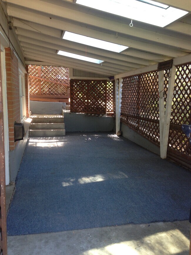 Enclosed, covered patio and access to the fenced backyard. - 5590 W 1st Ave