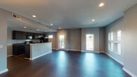 Located at 3727 Lausanne Dr in Nashville, Tennessee, this single-story home offers a well-designed, open-concept layout with a clean, modern aesthetic throughout. The main living area is expansive and filled with natural light from multiple windows and a glass exterior door, all set atop rich, dark hardwood-style flooring. Recessed lighting and a decorative chandelier add warmth and dimension to the space.

The kitchen is thoughtfully appointed with dark espresso cabinetry, granite-style countertops, and a full suite of black appliances including a range, built-in microwave, dishwasher, and refrigerator. A peninsula with a sink provides additional prep space and serves as a natural divider between the kitchen and living areas.

The bedrooms are finished with plush carpeting and feature ceiling fans, ample natural light from exterior-facing windows, and easy access to closet space. The primary bathroom includes a dark vanity with a white countertop, a large mirror, and a walk-in shower, with an adjacent walk-in closet. The secondary bathroom offers a full vanity and a combined shower-tub unit, both finished with chrome fixtures and neutral gray tones consistent with the home's overall palette.
