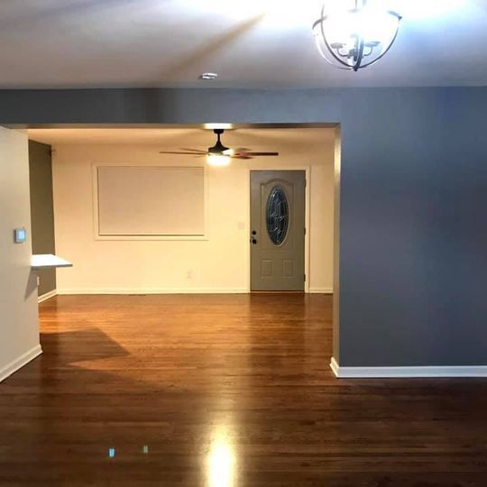 Living/Dining has updated lighting and massive ceiling fan. Area for a large dining table and small overhang for some stools. - 2814 N Saint Paul St