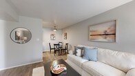 Located at 1115 W Putters Cir in Taylorsville, Utah, this one-bedroom, one-bathroom unit offers a thoughtfully designed single-floor layout that maximizes every square foot. The open-concept living and dining area serves as the heart of the home, featuring wood-look flooring, neutral gray walls, and a ceiling fan that adds both function and style. Large windows dressed with sheer white curtains allow ample natural light to fill the space, creating a bright and welcoming ambiance. The dining area sits adjacent to the living room, providing a seamless flow ideal for everyday living. The kitchen is efficiently appointed with dark espresso cabinetry, granite-style countertops, and stainless and black appliances including a range and refrigerator, complemented by matching wood-look flooring. The bedroom offers a comfortable, carpeted retreat with direct access to a dedicated walk-in closet complete with built-in shelving for organized storage. The full bathroom features dark wood vanity cabinetry, a granite-topped sink, mirrored medicine cabinet, and a tub-shower combination with stylish surround panels. Clean, consistent finishes throughout give the unit a cohesive and move-in-ready feel.