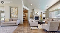 The Emerald Point Clubhouse at 2508 Gold Circle in Rocklin, California is a thoughtfully designed single-story community facility that serves as a central gathering hub for residents. The grand entry foyer sets an impressive tone with its soaring vaulted ceiling, arched transom windows, and glass double doors that flood the space with natural light. Neutral-toned sofas flank the entryway on polished tile flooring, creating a welcoming first impression.

Beyond the foyer, the clubhouse opens into a series of comfortable lounge and seating areas featuring patterned carpet, leather accent chairs, and built-in cabinetry with display shelving. An elegant glass-paned interior door connects these areas, accented by an arched wall niche that adds architectural character.

A dedicated business area includes a workstation with computer equipment and casual seating on carpet flooring, with a glass door leading directly outdoors. The kitchenette is outfitted with stainless steel appliances, including a refrigerator, built-in microwave, and dishwasher, complemented by granite countertops, white cabinetry, and a decorative tile backsplash.

The fitness center is well-equipped with treadmills, ellipticals, a stationary bike, and a free-weight rack, all set on durable rubber flooring with ceiling fans overhead and mirrored walls. A restroom corridor with dual water fountains and tile flooring provides practical amenities for all visitors.