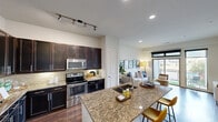 Located in the vibrant 78704 corridor of Austin, TX, this well-appointed one-bedroom, one-bathroom residence offers a thoughtfully designed open-concept floor plan. The kitchen serves as a central showpiece, boasting rich dark-espresso cabinetry, granite countertops, a tile backsplash, stainless steel appliances—including a refrigerator, range, and built-in microwave—and a peninsula island with bar seating, ideal for casual dining and entertaining. Track lighting overhead enhances both functionality and ambiance. Wood-style flooring flows seamlessly from the kitchen into the living area, where large floor-to-ceiling sliding glass doors and windows invite abundant natural light and provide direct access to a private balcony with open outdoor views. The bedroom is a comfortable retreat featuring plush carpet, dual windows, a ceiling fan, and a dedicated closet for ample storage. The full bathroom is finished with granite countertops, dark cabinetry, tile flooring, and a tiled tub-shower combination. Neutral wall tones throughout create a clean, modern backdrop, while recessed and track lighting ensure well-lit interiors. This residence combines practical design with contemporary finishes in one of Austin's most sought-after neighborhoods.