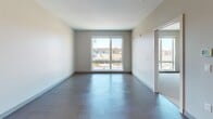 Located at 3686 Washington St in Boston's Jamaica Plain neighborhood, this modern 1-bedroom unit offers a thoughtfully designed single-floor layout that balances style and function. The open-concept living and kitchen area is anchored by wide-plank flooring and clean, neutral walls that create a bright and airy atmosphere. Large sliding windows in the living area frame views of the surrounding neighborhood while allowing abundant natural light to fill the space.

The kitchen is well-appointed with light wood cabinetry, white quartz countertops, a subway tile backsplash, and a full suite of stainless steel appliances including a Whirlpool refrigerator, electric range, over-the-range microwave, and dishwasher. A kitchen island provides additional counter space and a natural transition into the living area.

The bedroom continues the clean aesthetic with large windows that bring in daylight and open views. The bathroom features a full soaking tub with a combination shower, finished with crisp white subway-style wall tiles and polished chrome fixtures, delivering a clean, modern look. Recessed lighting throughout the unit adds to the contemporary feel of this well-designed Boston residence.