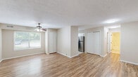 Located at 1361 Fox Run Dr in Willoughby, OH, this one-bedroom, one-bathroom unit offers a well-organized, single-floor layout that makes efficient use of its space throughout. The living area features warm wood-look plank flooring, a textured ceiling, and a ceiling fan, with a large window that invites natural light and views of the surrounding greenery. The layout flows naturally from the living room into a dedicated dining area and a well-appointed kitchen. The kitchen is outfitted with white shaker-style cabinetry, granite countertops, a subway tile backsplash, stainless steel dishwasher and refrigerator, and a window above the sink. The carpeted bedroom offers a comfortable retreat with a window overlooking lush outdoor trees and two closets for generous storage. The bathroom includes tile flooring, a full tub-shower combination with tiled surround, a white vanity with granite countertop, and a large mirror. A dedicated laundry area and multiple closets throughout — including one in the hallway — add practical storage solutions. The neutral color palette, consistent finishes, and functional layout make this a well-rounded and move-in-ready space.