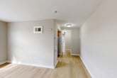 This one-bedroom, one-bathroom residence at 1625 Morris Rd SE in Washington, DC offers a thoughtfully laid-out single-floor plan. Light-toned hardwood flooring runs throughout, lending a clean and cohesive aesthetic to every room.

The combined living and dining area serves as the heart of the home, with natural light streaming through large windows fitted with blinds. Neutral warm-gray walls and crisp white trim create a bright, welcoming ambiance. A wall-mounted HVAC unit and floor vents ensure year-round comfort.

A central hallway connects the main living spaces to the bedroom, bathroom, and kitchen, providing a logical flow through the home. The kitchen is positioned off the hallway and features stainless steel appliances. Three closets distributed throughout the unit offer generous storage.

The bedroom is a well-proportioned, quiet retreat with a window overlooking greenery, neutral walls, and light hardwood floors. A set of bi-fold closet doors provides convenient wardrobe storage.

The bathroom is finished with white tile wainscoting, a gray vanity with a white sink, a mirrored medicine cabinet, and a full bathtub/shower combination. A window provides natural light and ventilation. A utility room rounds out the layout, adding practical functionality to this efficiently designed Washington, DC residence.