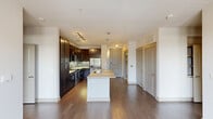 Located at 4678 Amesbury Dr in Dallas, TX, this 2-bedroom, 3-bathroom residence offers a well-designed single-floor layout. The heart of the home is an open-concept kitchen featuring rich dark wood cabinetry with glass-front upper panels, a tiled mosaic backsplash, stainless steel appliances, and a large center island topped with light granite countertops. Pendant lighting and track lighting illuminate the space, while wide-plank hardwood floors extend throughout the main living areas. The kitchen flows seamlessly toward the living space, with natural light visible from nearby windows. The bedrooms are carpeted and finished with clean, neutral walls, providing a calm and versatile backdrop. The primary bedroom includes an en-suite bathroom with a granite vanity, a soaking tub with tiled surround, and direct access to a well-organized walk-in closet featuring built-in shelving and hanging rods. Additional bathrooms maintain a consistent clean aesthetic with tile flooring and tub-shower combinations. A dedicated laundry room includes shelving and all necessary utility connections, adding everyday convenience. The closet offers built-in shelving for ample storage.