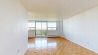 Located on the 12th floor at 1360 Danforth Rd in Toronto's Scarborough area, this well-appointed 2-bedroom, 1-bathroom unit offers a comfortable and functional layout across a single floor. Warm parquet flooring flows consistently throughout the living areas and bedrooms, lending a classic and cohesive aesthetic to the space.

The living room is a standout feature, boasting a full wall of large sliding windows and balcony access that frames expansive treetop and skyline views, filling the room with abundant natural light. The renovated kitchen is thoughtfully designed with white shaker-style cabinetry, dark countertops, a white subway tile backsplash, and stainless steel appliances including a refrigerator, dishwasher, stove, and built-in microwave.

The spacious primary bedroom comfortably accommodates a full suite of furniture and includes dual sliding closets for ample storage. The second bedroom also features parquet flooring, a window with natural light, and generous wall space. The bathroom is finished with crisp white subway tile surrounding a full bathtub and shower combination, complemented by clean, bright fixtures.

The unit's bright, neutral palette and updated finishes create a clean, move-in-ready environment in a well-established Toronto neighbourhood.