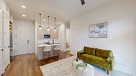 Located in Houston's desirable 77008 zip code, this well-appointed 2-bedroom, 2-bathroom residence offers a thoughtfully designed open-concept layout with modern finishes throughout. Wide-plank hardwood flooring runs through the main living areas, anchoring a bright and airy aesthetic defined by crisp white walls and recessed lighting.

The kitchen is a standout feature, showcasing light wood cabinetry, white quartz countertops, a subway tile backsplash, and a full suite of stainless steel appliances including a French door refrigerator, electric range, and built-in microwave. A peninsula with seating for two and stylish pendant lighting makes it ideal for casual dining and entertaining. The combined living and dining area flows seamlessly from the kitchen, with a ceiling fan and French doors inviting natural light.

The primary bedroom connects to a spa-inspired en-suite bathroom featuring marble-look tile flooring, a dual-sink vanity with light wood cabinetry, matte black hardware, and a glass-enclosed shower. The second bedroom, versatile enough for a home office, includes a walk-in closet. A second full bathroom offers a tub-shower combination with elegant marble-look tile surround. The unit also includes multiple closets, a dedicated laundry area, and an entrance hallway.