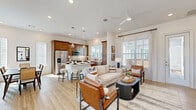 Located in Cypress, TX, this well-appointed 2-bedroom, 2-bathroom single-story home offers a thoughtfully designed open-concept layout that seamlessly connects the living, dining, and kitchen areas. Light wood-look flooring runs throughout the main living spaces, complemented by crisp white walls and abundant natural light streaming through multiple windows with blinds.

The kitchen is a standout feature, boasting rich warm-toned shaker cabinetry extending to the ceiling, white quartz countertops, a neutral tile backsplash, and a full suite of stainless steel appliances including a French door refrigerator, electric range, microwave, and dishwasher. A breakfast bar island provides additional seating and flows into the dining area, which is brightened by tall windows.

The living room offers a welcoming atmosphere with a ceiling fan, recessed lighting, and a glass door providing outdoor access. Both bedrooms are carpeted and feature natural light from exterior windows. The primary bedroom is generously proportioned with dedicated closet space. The bathrooms are finished with warm wood cabinetry, framed mirrors, light tile flooring, and well-lit vanities. This home combines functional design with modern finishes throughout.