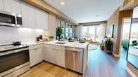 Located at 110 Constitution Dr in Menlo Park, CA, this well-appointed one-bedroom, one-bathroom residence offers a thoughtfully designed open-concept layout across a single floor. Warm hardwood-style flooring flows throughout, unifying the living, dining, and kitchen areas into a cohesive and inviting space.

The kitchen is a standout feature, outfitted with light wood flat-front cabinetry, a white subway tile backsplash, sleek quartz countertops, and a full suite of stainless steel appliances including a range, dishwasher, microwave, and refrigerator. A peninsula with bar seating makes it ideal for both casual dining and entertaining.

The living room is bright and airy, anchored by a large floor-to-ceiling window that fills the space with natural light and provides outdoor views. A curated gallery wall and an emerald green curved sofa add a sophisticated, artistic touch to the warm-toned room.

The bedroom continues the refined aesthetic with a bold geometric accent wall in earthy tones of green, gold, and ochre. A large window offers abundant natural light and outdoor views, creating a serene retreat.

The bathroom features deep green accent walls contrasted by light wood vanity cabinetry, a white quartz countertop, large-format tile flooring, and an illuminated mirror, delivering a clean, modern finish. A dedicated closet and hallway complete the thoughtfully organized layout.