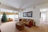 Located at 902 Stonecrest Ln in Gaffney, South Carolina, this well-laid-out 2-bedroom, 2-bathroom single-story home offers a comfortable and functional floor plan. The living room features warm neutral-toned carpet, crisp white walls, and an open passage leading into a bright, windowed sitting area. This secondary lounge space is bathed in natural light through multiple windows adorned with decorative valances, creating an airy and inviting atmosphere. The kitchen is efficiently designed with warm wood cabinetry, ample counter space, tile flooring, and black appliances including a refrigerator, range, and dishwasher. A connecting pass-through window adds an open feel between the kitchen and adjoining areas. Both bedrooms are carpeted and well-lit with natural light from windows featuring blinds and curtains. The primary bedroom offers a generous footprint with closet access, while the secondary bedroom provides a cozy and comfortable retreat. Each of the two full bathrooms includes a tub/shower combination, tile flooring, and a wood-toned vanity with a white countertop. A hallway connects the living spaces to the bedrooms and bathrooms, ensuring a practical and seamless flow throughout the home.