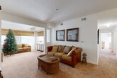 Located at 902 Stonecrest Ln in Gaffney, South Carolina, this well-laid-out 2-bedroom, 2-bathroom single-story home offers a comfortable and functional floor plan. The living room features warm neutral-toned carpet, crisp white walls, and an open passage leading into a bright, windowed sitting area. This secondary lounge space is bathed in natural light through multiple windows adorned with decorative valances, creating an airy and inviting atmosphere. The kitchen is efficiently designed with warm wood cabinetry, ample counter space, tile flooring, and black appliances including a refrigerator, range, and dishwasher. A connecting pass-through window adds an open feel between the kitchen and adjoining areas. Both bedrooms are carpeted and well-lit with natural light from windows featuring blinds and curtains. The primary bedroom offers a generous footprint with closet access, while the secondary bedroom provides a cozy and comfortable retreat. Each of the two full bathrooms includes a tub/shower combination, tile flooring, and a wood-toned vanity with a white countertop. A hallway connects the living spaces to the bedrooms and bathrooms, ensuring a practical and seamless flow throughout the home.