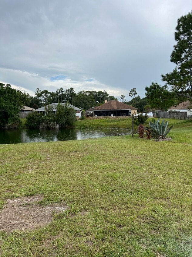 Water view from the living room and back patio — ideal for peaceful relaxation. - 5374 Lacy Jane Way