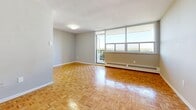 Located at 6040 Bathurst Street in North York, Toronto, this well-laid-out two-bedroom, one-bathroom unit offers a comfortable and functional living experience across a single floor. The living and dining area is an open, airy space anchored by classic parquet wood flooring that extends throughout the unit. Floor-to-ceiling windows and a walkout balcony flood the living room with natural light and provide sweeping outdoor views, creating a bright and welcoming atmosphere. The kitchen is clean and functional, featuring white shaker-style cabinetry, a subway tile backsplash, light tile flooring, stainless steel appliances including a refrigerator and range, and ample counter and storage space. Both bedrooms continue the warm parquet flooring and are generously sized, each equipped with large sliding-door closets providing excellent storage. The primary bedroom offers a spacious layout with room for full furnishing. The bathroom is finished with crisp white wall tiles and includes a full soaker tub with a shower. Three closets are distributed throughout the unit, enhancing storage options. A dedicated entrance and private balcony round out this well-organized home, ideal for comfortable urban living in Toronto.