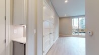 This contemporary 660 square foot apartment offers a thoughtful blend of comfort and urban sophistication. The single-floor layout maximizes space efficiency, featuring one bedroom and two bathrooms. The heart of the home is an open-concept kitchen and living area, designed for seamless flow and functionality.

The standout feature is a large sliding glass door leading to a private balcony, flooding the space with natural light and offering urban views. Light-colored walls and carpeting create an airy ambiance, while recessed lighting adds a modern touch. The 150 square foot primary bedroom provides ample space for rest and relaxation.

With its clean lines and neutral palette, this apartment serves as a blank canvas for personal style. The additional bathroom adds convenience for guests or could serve as an en-suite. Despite its compact size, the thoughtful design ensures no wasted space, making it an ideal option for those seeking efficient city living without compromising on amenities or style.