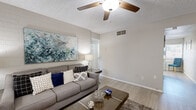 Located at 615 S Hardy Dr in Tempe, Arizona, this single-floor, two-bedroom, one-bathroom residence offers a well-organized and thoughtfully updated layout. The living room serves as the heart of the home, featuring light wood-style flooring, a ceiling fan, a textured ceiling, and an exposed painted brick accent wall that adds a distinctive character to the space. Natural light filters in through a front-facing window, creating a bright and welcoming atmosphere.

The kitchen has been modernized with white shaker-style cabinetry, a subway tile backsplash, and a full suite of stainless steel appliances, including a refrigerator, range, microwave, and dishwasher. Light flooring and a window bring additional brightness to this functional space.

The primary bedroom is a comfortable retreat featuring a ceiling fan, a shiplap-style accent wall, and a window with outdoor views of lush greenery. The second bedroom also includes a ceiling fan, a window with natural light, and exposed brick walls, offering a versatile space suitable for various uses.

The single bathroom is clean and contemporary, with a floating wood-tone vanity, white countertop, tile flooring, and a full tub-shower combination. Two closets provide practical storage throughout the unit, and two hallways connect the rooms efficiently.