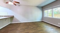This 520 square foot apartment in Nashville, TN offers a thoughtful layout maximizing space and functionality. The single-floor unit comprises one bedroom, one bathroom, and an open-concept kitchen and living area. The primary bedroom, measuring 160 square feet, features plush carpeting and a window allowing natural light. The living area boasts wood-look flooring and a large window, creating a bright, airy atmosphere. The kitchen, while compact, is efficiently designed with white cabinetry, subway tile backsplash, and granite countertops. Modern appliances enhance its functionality. The bathroom showcases elegant marble-look tiling and a white bathtub. Throughout the apartment, neutral wall colors provide a canvas for personalization. A ceiling fan in the living area aids in air circulation. The property's design emphasizes natural light with multiple windows offering views of the surrounding greenery, contributing to a fresh and inviting living space.
