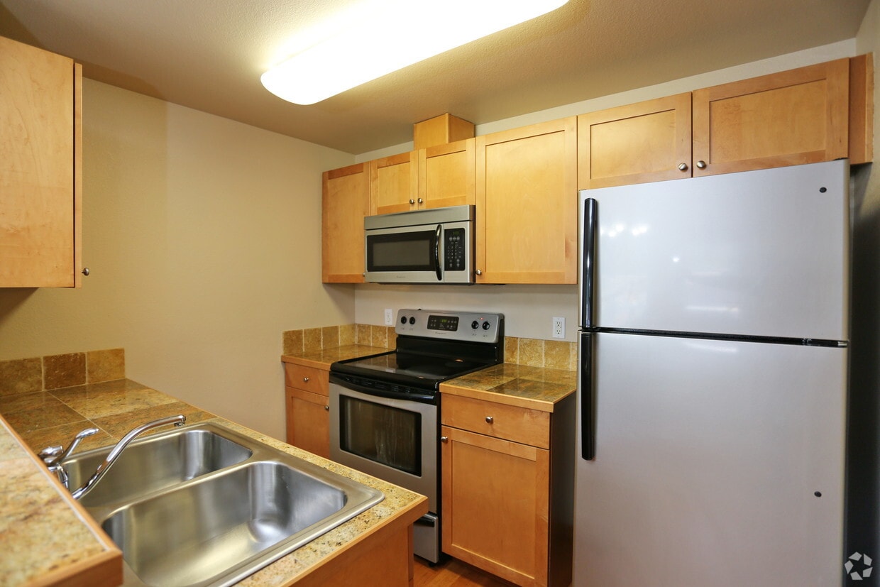 Top floor kitchen - please note cabinets and counters vary! - Harbor Pointe Apartments