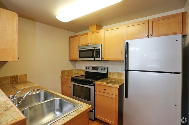Top floor kitchen - please note cabinets and counters vary! - Harbor Pointe Apartments