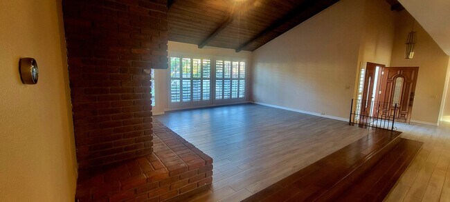 Living room with brick fireplace - 16139 Ladera Piedra Way