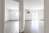 Located at 240 Prospect Ave in Hackensack, NJ, this 2-bedroom, 1-bathroom unit offers a clean, modern aesthetic throughout. Light wood-style flooring runs continuously across the living areas, complemented by crisp white walls and textured ceilings that create a bright, airy atmosphere. The spacious living room is a standout feature, bathed in natural light from a large sliding glass door that opens to a private balcony, offering outdoor views. A wall-mounted A/C unit and baseboard heating ensure year-round comfort. The galley-style kitchen is thoughtfully updated with gray shaker cabinets, white quartz countertops, a stainless steel sink, and stainless steel appliances including a refrigerator, electric range, and dishwasher. The primary bedroom is generously sized, with a large window allowing ample natural light, while the second bedroom includes a built-in closet with shelving for convenient storage. The bathroom has been elegantly renovated, showcasing large-format marble-look tile on both the floors and tub surround, paired with a white vanity and chrome fixtures for a polished finish. Hallways connect the rooms efficiently, contributing to a functional and cohesive layout throughout the unit.