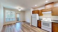 Located at 184 Tonea Way in Chico, California, this one-bedroom, one-bathroom unit offers a practical and well-designed single-floor layout. Light wood-style flooring runs consistently throughout the space, creating a clean, cohesive look that ties each room together.

The kitchen is a standout feature, offering an L-shaped configuration with abundant warm-toned wood cabinetry extending to the ceiling for generous storage. Dark granite-style countertops contrast neatly with white appliances, including a refrigerator, electric range, and dishwasher. Recessed lighting illuminates the workspace effectively, and the kitchen opens directly to the living area, enhancing the sense of openness.

The bedroom is a comfortable, well-proportioned room featuring a large window that fills the space with natural light and frames a lush, green outdoor view — a calming and pleasant focal point. Neutral walls and the same light flooring maintain a bright, airy atmosphere.

The bathroom is clean and functional, featuring a full soaking tub with a white surround, light wood-style flooring, and a brushed nickel grab bar and towel bar. The layout is straightforward and easy to navigate.

A hallway connects the rooms efficiently, completing a practical floor plan that makes thoughtful use of every square foot in this Chico residence.