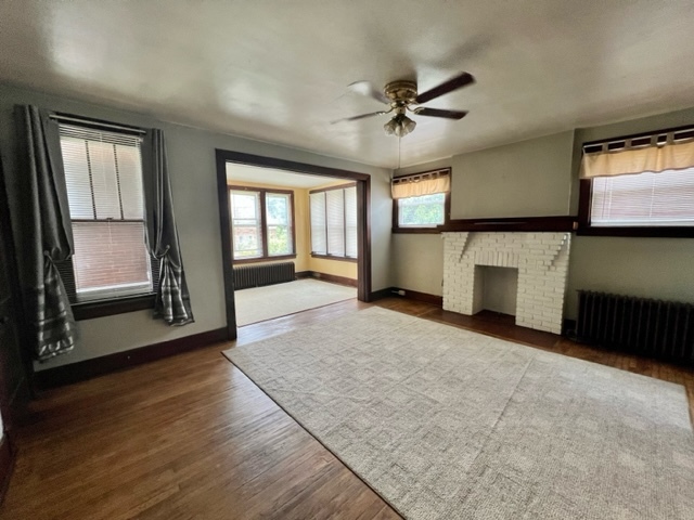 View of living room with fireplace and sunroom - 180 Noble Ave