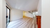 Located at 13719 Oxnard Street in the Van Nuys neighborhood of Los Angeles, this two-story home offers four bedrooms and four bathrooms distributed evenly across both floors. Light-toned hardwood flooring runs throughout the interior, lending a cohesive, clean aesthetic to the entire space.

The main level features a welcoming entrance that flows into the living areas, complemented by a galley-style kitchen equipped with granite countertops, white cabinetry, stainless steel appliances including a gas range and dishwasher, and a window with vertical blinds that allows natural light to brighten the space.

The bedrooms are well-proportioned, with the generously sized primary bedroom featuring a sliding closet and direct access to a private en-suite bathroom. The en-suite includes a wide vanity with granite countertops, white cabinetry, and a large mirror with overhead lighting. The additional bathrooms are finished with neutral tile flooring and tub-shower combinations featuring marble-style tile surrounds.

A staircase with glass railing connects both floors, enhancing the open feel of the layout. The upper level mirrors the lower floor's footprint, providing a balanced and functional arrangement. Throughout the home, bright white walls, recessed lighting, and consistent flooring create a clean, move-in-ready environment.