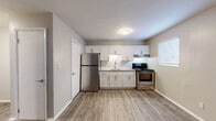Located at 2716 Buford Hwy in Atlanta, GA, this one-bedroom, one-bathroom unit offers a thoughtfully designed single-floor layout. Wood-look flooring flows consistently throughout the space, creating a cohesive and clean aesthetic.

The open-concept living, dining, and kitchen area serves as the heart of the unit. The kitchen is well-appointed with crisp white shaker cabinets, granite-look countertops, a white subway tile backsplash, and a full suite of stainless steel appliances including a refrigerator and electric range. A window brings in natural light, enhancing the bright and functional workspace. A pantry provides additional storage.

The living area is open and versatile, featuring a wall-mounted HVAC unit and a large window that allows natural light to fill the room. The entry door opens directly into this space, offering a welcoming flow.

The bedroom is a comfortable, well-proportioned room with wood-look flooring, neutral walls, and access to closet storage. The full bathroom features a clean white tub-shower combination, granite-topped vanity with white cabinetry, and wood-look tile flooring. Two closets provide ample storage throughout the unit. The overall design is clean, modern, and move-in ready.