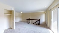 Located at 411 East Gibbsboro Road in Lindenwold, New Jersey, this property offers a clean and functional layout designed with practicality and comfort in mind. The interior is characterized by neutral, warm-toned walls that create a bright and welcoming ambiance throughout. Plush wall-to-wall carpeting runs across the main living area, adding softness and warmth underfoot. A standout architectural feature is the centrally positioned staircase, framed by a dark wood and metal balustrade that introduces a touch of contrast and visual interest against the lighter surroundings. Recessed lighting and a flush-mount ceiling fixture ensure the space is well-lit, complementing the natural light that filters in through the windows. The open layout of the main level offers flexibility in furnishing and use, making it adaptable to a variety of needs. White-painted trim and door frames provide clean definition throughout the space, contributing to a cohesive and polished aesthetic. The overall atmosphere is calm, neutral, and move-in ready, offering a solid foundation for personalization and comfortable everyday living in the Lindenwold community.