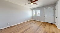 Located at 444 Florida St SE in Albuquerque, New Mexico, this one-bedroom, one-bathroom unit offers a thoughtfully arranged single-floor layout that makes excellent use of its compact footprint. Warm-toned luxury vinyl plank flooring flows consistently throughout the living areas and bedroom, lending the space a cohesive, modern aesthetic.

The living room is bright and open, featuring a ceiling fan with light kit and a window that allows natural light to fill the space. Soft gray walls and clean white trim create a calm, neutral palette throughout. The kitchen is efficiently laid out with white shaker-style cabinetry, granite-patterned countertops, white appliances including a refrigerator and range, and a window above the sink that provides additional natural light.

The bedroom is a comfortable size, complete with a sliding double-door closet for ample storage, a ceiling fan, and a window with views to the outdoors. Overhead vents ensure efficient climate control throughout the unit.

The bathroom features a full soaking tub surrounded by large-format marble-look tile that extends up the walls, paired with a frosted window for natural light and privacy. The overall design of this unit is clean, updated, and move-in ready, offering a functional and comfortable living environment in a well-established Albuquerque neighborhood.