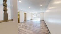 Located at 1150 S Main St in Middletown, Connecticut, this single-floor residence offers a well-organized layout with a clean, updated aesthetic throughout. The open living area is a standout feature, showcasing light-toned hardwood-style flooring, recessed lighting, a textured ceiling, and a sliding glass door that opens to a private deck, allowing natural light to fill the space. An adjacent area with warm wood-tone flooring and recessed lighting provides additional flexible living space.

The kitchen is thoughtfully appointed with gray and white cabinetry, granite-style countertops, a mosaic tile backsplash, and stainless steel appliances, including an electric range and refrigerator. The galley-style layout maximizes efficiency and storage.

The bedrooms feature durable multi-tone hardwood-style flooring, warm neutral walls, baseboard heating, and ample natural light from windows with outdoor views. At least one bedroom includes a sliding-door closet with built-in shelving for convenient storage.

Two bathrooms serve the unit, both finished with mosaic tile flooring. One features a glass-enclosed shower stall, while the other offers a full tub/shower combination with sliding glass doors, a wood-toned vanity, and a mirrored medicine cabinet. Together, these spaces deliver a comfortable and functional living environment.