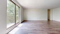 Located at 530 Mornington Ave in London, Ontario, this well-appointed 2-bedroom, 2-bathroom unit offers a functional and comfortable single-floor layout. The living room is a standout space, featuring large sliding glass doors that flood the room with natural light and open onto a private balcony with pleasant tree-lined views. Durable hardwood-style laminate flooring runs throughout the main living areas and bedrooms, contributing to a clean, cohesive aesthetic. The galley-style kitchen is efficiently designed with white shaker cabinetry, dark countertops, a subway tile backsplash, tile flooring, and stainless steel appliances including a refrigerator and range. Both bedrooms are well-sized, with the primary bedroom offering ample space, a closet, and a window for natural light. The second bedroom also features a sliding closet and direct hallway access. The two bathrooms are finished with neutral tones; one includes a soaker tub with classic white subway tile surround, while the other features a white vanity with mirror. Baseboard heating is present throughout. The overall palette of white walls, light flooring, and bright windows creates a fresh, airy ambiance throughout the unit.