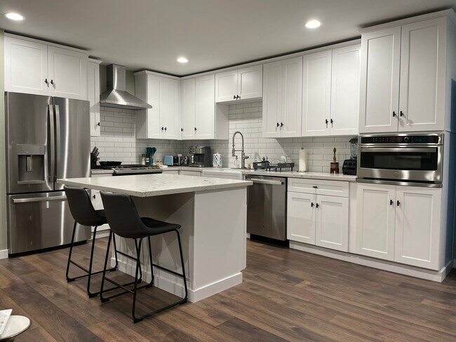 Full-size open kitchen with premium stainless appliances and quartz counters and island. - 1755 Mission Cliff Dr