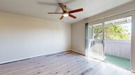 This well-appointed 2-bedroom, 1-bathroom single-story residence in Phoenix, Arizona offers a clean, modern aesthetic throughout. Light wood-tone laminate flooring runs continuously across all rooms, creating a cohesive and bright interior. The open living area is anchored by a ceiling fan and features a sliding glass door that floods the space with natural light while providing direct access to an outdoor patio area.

The galley-style kitchen is efficiently designed with white shaker cabinetry, gray quartz countertops, a subway tile backsplash, and a full suite of stainless steel appliances, including a refrigerator, range, microwave, and dishwasher. An open pantry with built-in shelving provides convenient additional storage.

Both bedrooms are comfortably sized and include ceiling fans for year-round comfort. The primary bedroom features a mirrored sliding closet door alongside an additional built-in closet with shelving and a hanging rod, maximizing storage. The second bedroom also includes a mirrored closet and a window with natural light. The shared full bathroom includes a shower-tub combination and overhead storage.

Neutral wall tones, consistent flooring, and practical built-in storage throughout make this residence a functional and inviting home in the desirable Thomas Road corridor of Phoenix.