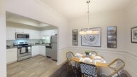Located on Ann Marie Way in Knoxville, Tennessee, this two-story residence offers a thoughtfully designed layout spread across two levels. The main living area is warm and inviting, featuring wood-style flooring, a ceiling fan, and a classic wooden staircase with decorative balusters that serves as a focal point of the space. French doors flood the room with natural light and provide access to the outdoors, contributing to an airy, open ambiance throughout.

Adjacent to the living area, the dining room is distinguished by elegant wainscoting along the lower walls, crown molding, and a modern multi-bulb chandelier overhead, creating a polished, refined atmosphere well-suited for entertaining.

The kitchen is efficiently organized with ample white cabinetry featuring arched door detailing, dark granite-style countertops, and a full suite of stainless steel appliances including a range, microwave, dishwasher, and refrigerator. A tray ceiling adds architectural dimension to the space.

The bathroom includes a granite-style integrated sink vanity with white cabinetry and a large mirror. Wood-style flooring is consistent throughout the main living spaces, unifying the overall aesthetic of the home with a clean, contemporary character.