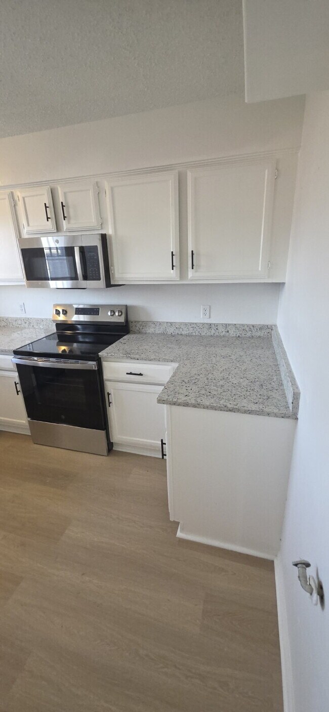 Building Photo - Beautifully remodeled first-floor condo with fence yard & carport!