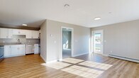 Located at 231 Scarborough Downs in Scarborough, Maine, this single-floor, 2-bedroom, 1-bathroom residence offers a clean, modern design with a functional and comfortable layout. The open living area is bathed in natural light streaming through large windows, highlighting warm hardwood-style flooring and neutral-toned walls throughout. A mini-split system and baseboard heating ensure year-round comfort.

The kitchen is well-equipped with crisp white shaker cabinets, granite-look countertops, and a full suite of stainless steel appliances including a refrigerator, dishwasher, range, and microwave. Hardwood-style flooring extends seamlessly into this space, adding to its bright, cohesive feel.

Both bedrooms feature plush carpeting, generous windows with outdoor views, and baseboard heating. The primary bedroom includes a closet with built-in shelving for ample storage. The second bedroom also benefits from natural light and a similarly comfortable atmosphere.

The bathroom is finished with wood-look luxury vinyl flooring, a white vanity with brushed nickel hardware, and a tub-shower combination. Throughout the residence, clean white trim and a neutral color palette create a fresh, move-in-ready environment well-suited for everyday living in coastal Maine.