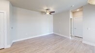 Located at 9275 Lyndon B Johnson Fwy in Dallas, TX, this one-bedroom, one-bathroom residence offers a thoughtfully designed single-floor layout with a clean, contemporary aesthetic throughout. The open-concept living area seamlessly connects the kitchen, dining, and living spaces, all finished with light wood-look flooring that enhances the bright, airy feel of the space. The kitchen is a standout feature, equipped with stainless steel appliances including a range, microwave, and refrigerator, complemented by granite countertops, white shaker-style cabinetry, and a peninsula island with pendant lighting overhead — ideal for casual dining or entertaining. The living area is spacious and well-lit, with a ceiling fan adding comfort. The bedroom is carpeted for warmth and comfort, featuring a ceiling fan, multiple windows with blinds that allow natural light and outdoor views, and ample closet storage with four closets total throughout the unit. The full bathroom includes a tiled tub-surround, granite vanity countertop, and gray cabinetry. Additional highlights include an in-unit laundry area, a private balcony, and a neutral color palette that creates a cohesive and inviting atmosphere throughout.