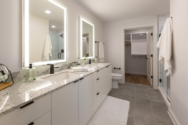 Backlit Vanity Mirror in All Bathrooms | B3 Marbled Counter Scheme | 2 Bedroom | 1106 Sq. Ft. - Loria Ansley Apartments